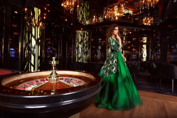 A professional dealer in a tuxedo greeting players at the roulette table, symbolizing the authentic live casino feel at BK33.