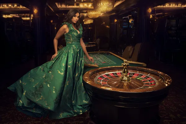 A man celebrating a winning moment on his laptop while gaming symbols float around him, capturing the excitement of BK33 games.